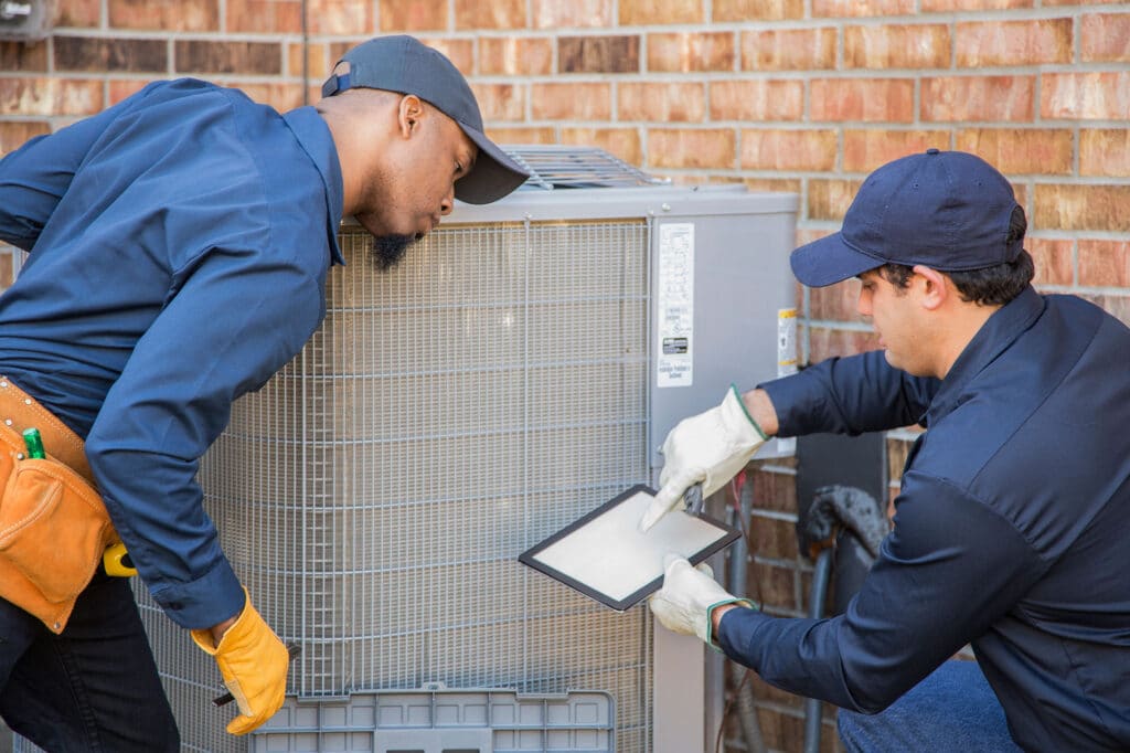 air-conditioning-techs-troubleshooting-1132791347