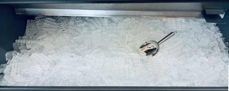 Ice cubes store in ice making machine for clean product. Ice cube maker. Cube ice machine. Suitable for small beverage shops.
